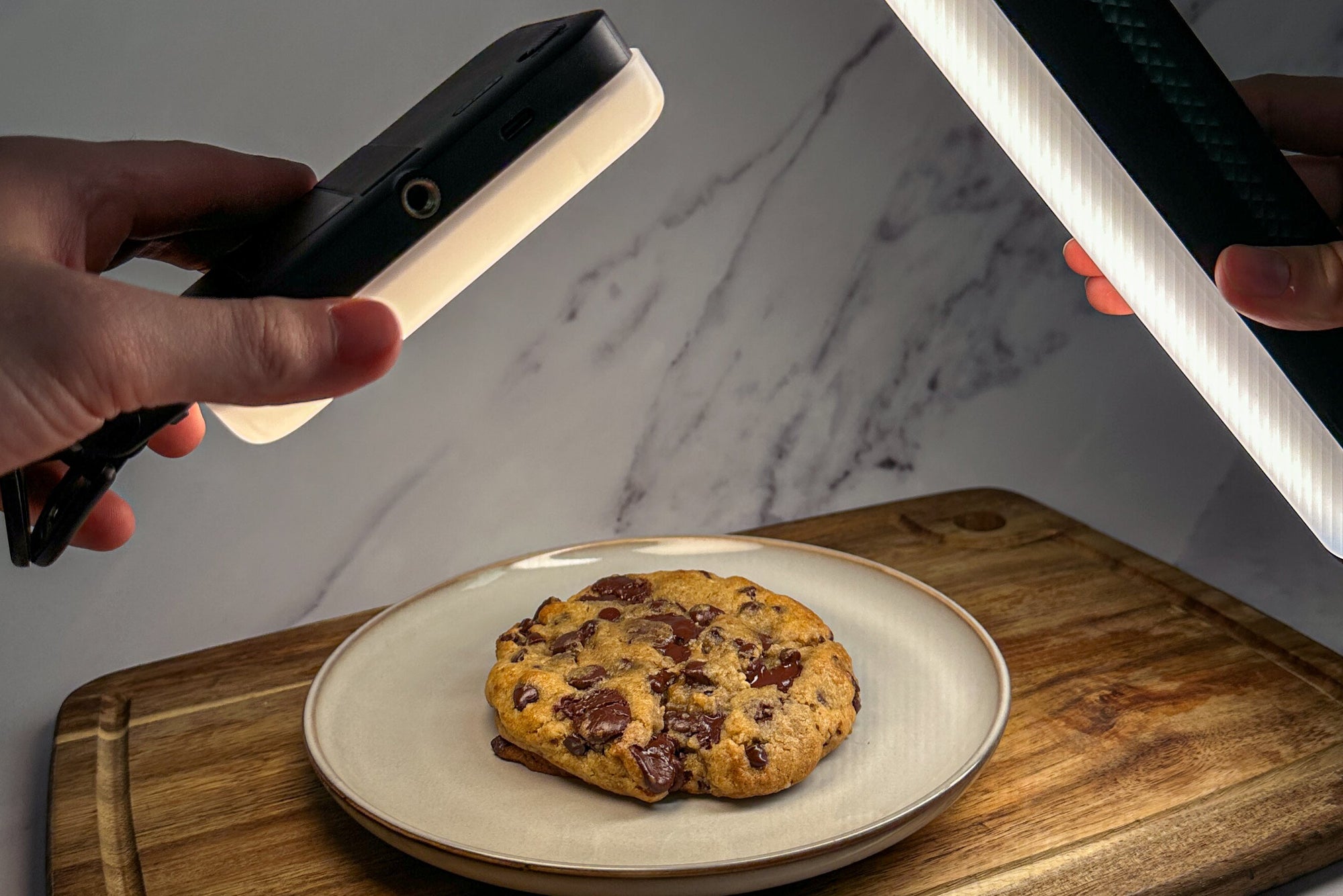 Obsessing over a plate of warm, soft, gooey chocolate chip cookies on a wooden cutting board.