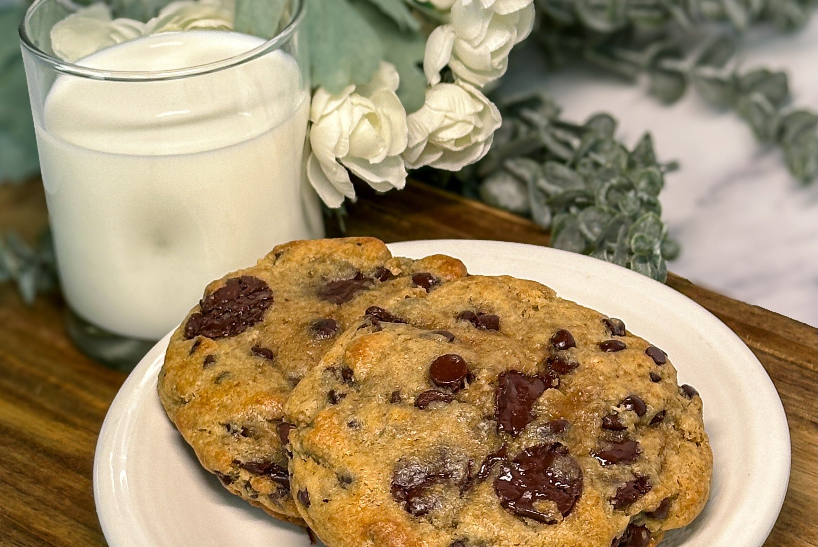 Thick gooey chocolate chip cookie with melted chocolate chunks, fresh baked bakery style cookie on plate